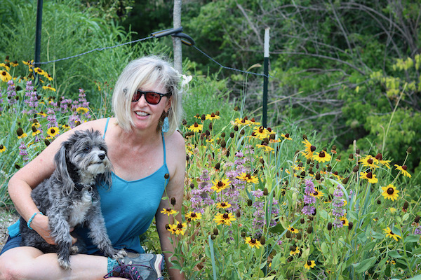 Leonard takes a break from her efforts with her dog Kloe. Photo by Tony Adler.