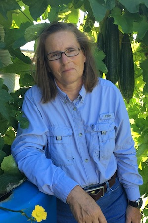 Deb Terrell with her luffa plants.