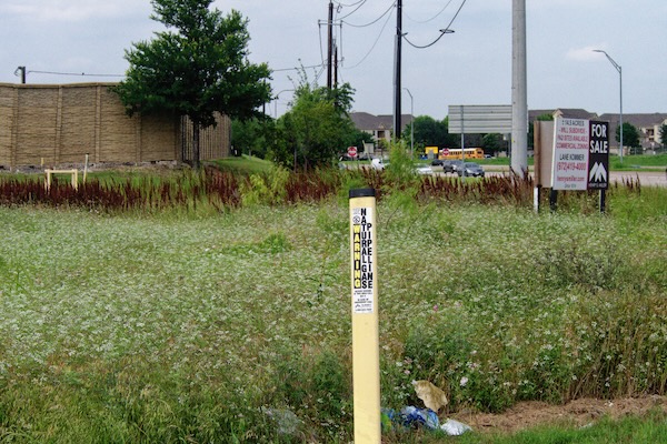 A for-sale sign is posted next to the Fulson drilling site at 5720 S. Watson Road. Photo by J.G. Domke.