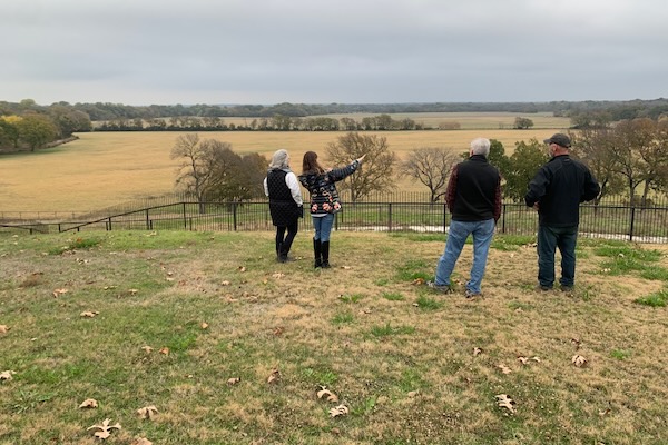 Ann Woodbridge, Anne Beckmann, Ned Woodbridge and Randy Lincoln looked over the low lying prairie off Hartlee Field Road in November 2023. The area is home to unique vegetation, a plethora of wildlife and sensitive floodplains. Photo by Kaley Johnson.
