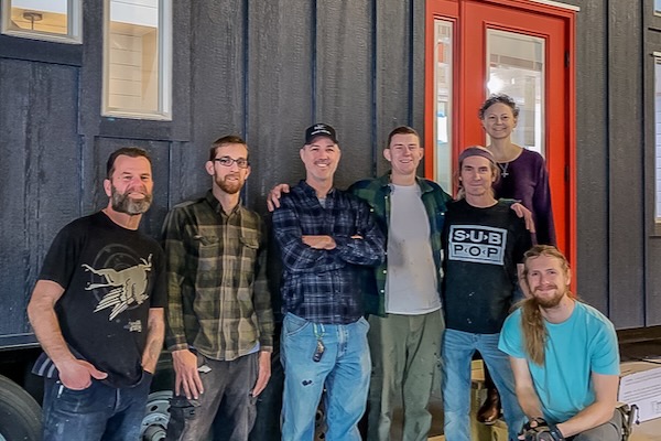 Peter Huggler, center, and Christina Wester with the Indigo River Tiny Homes crew. Courtesy of Indigo River Tiny Homes.