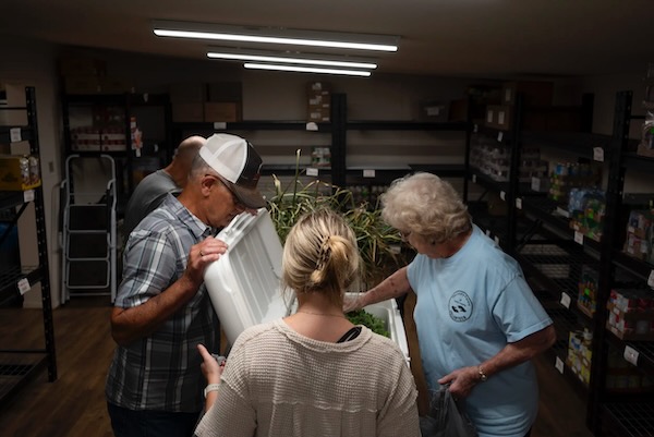 Volunteers prepare fresh vegetables donated by the Dewey Prairie Garden for distribution at the Lord’s Pantry of Leon County in Buffalo. Photo by Joe Timmerman, The Texas Tribune.