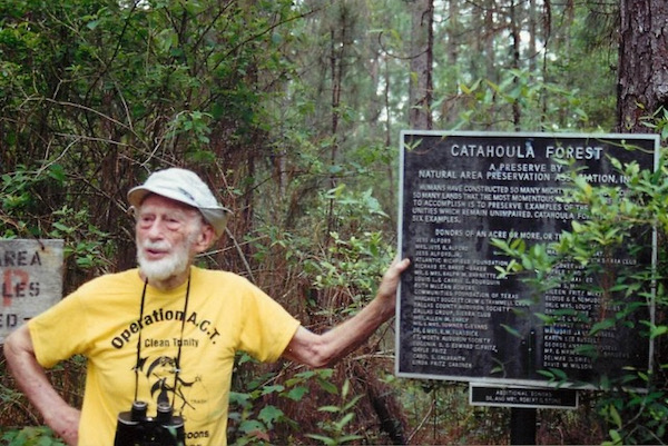 Ned with the sign honoring the acquisition of Catahoula Preserve in East Texas by Natural Area Preservation Association, now Texas Land Conservancy (TLC). Photo courtesy of TLC. 