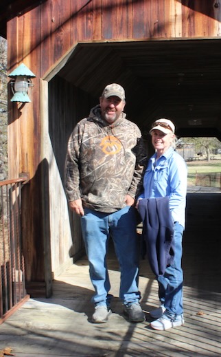 Kelly Langdon (left) and his mother, Karen Langdon (right) on a bridge over Fall Creek