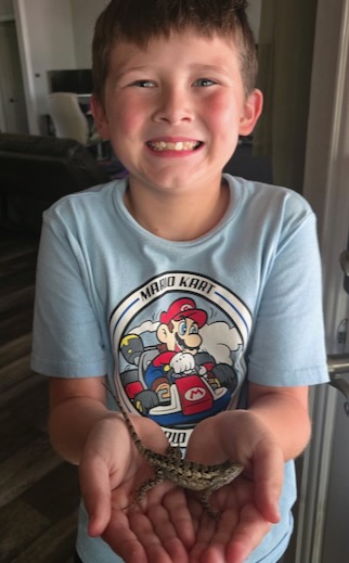 Jenna's son Mark with a Texas spiny lizard.