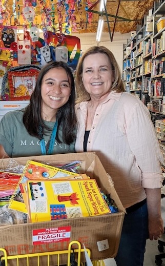 Ashlyn Geismar and Mimi Morris scope out classroom supplies at the Welman Project.