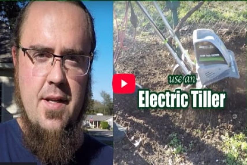 Man outdoors; electric tiller on soil.