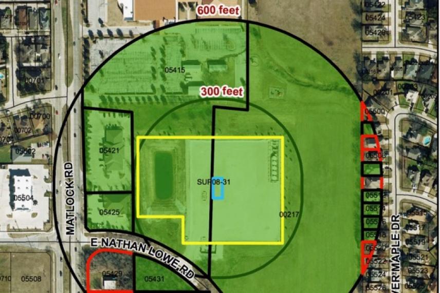 Map with highlighted zones, roads, and buildings in green, yellow, and red.