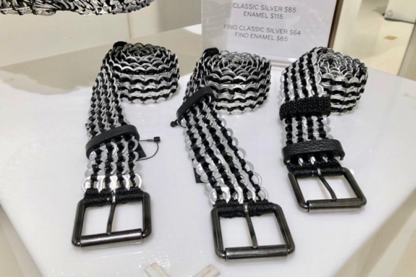 Black and white striped belts with square buckles on display.