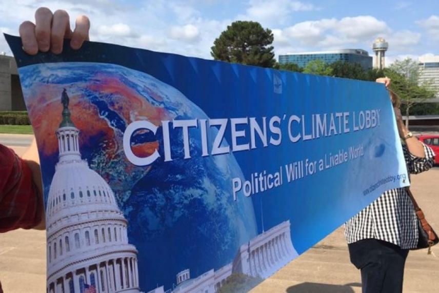 A banner reading “Citizens' Climate Lobby” in front of a blue sky.