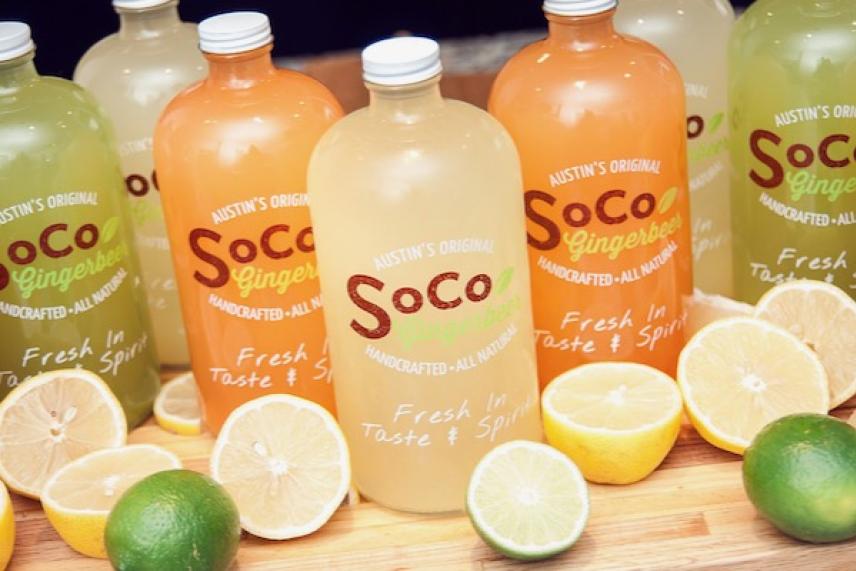 SoCo ginger ale bottles surrounded by sliced lemons and limes.