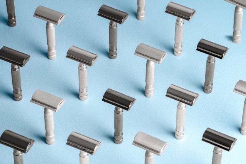 Razors arranged upright on a light blue background.