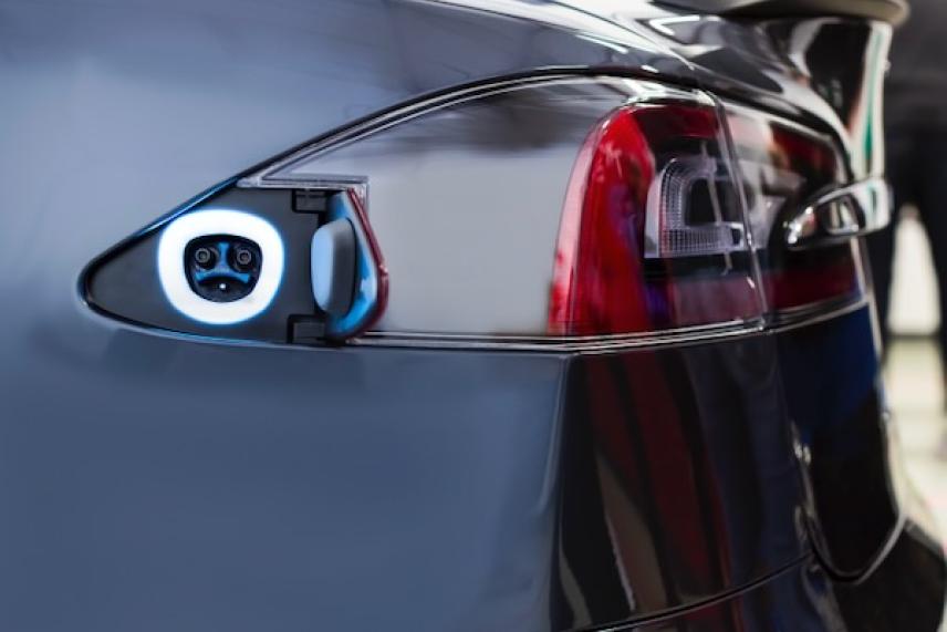 Electric car charging port on rear, with a lit ring indicator.