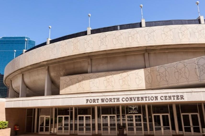 Fort Worth Convention Center's curved facade under a clear blue sky.