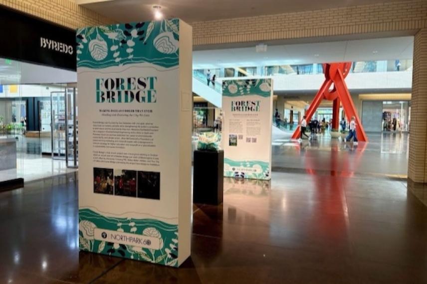 Exhibit display with teal graphics in a modern indoor setting.