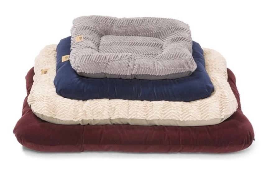 Stacked pet beds in burgundy, cream, navy, and grey.