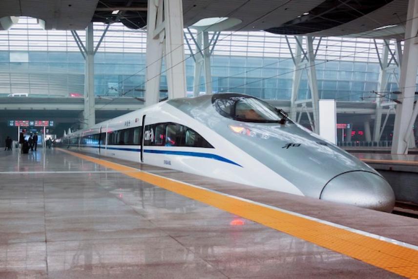 High-speed train at a modern railway station platform.