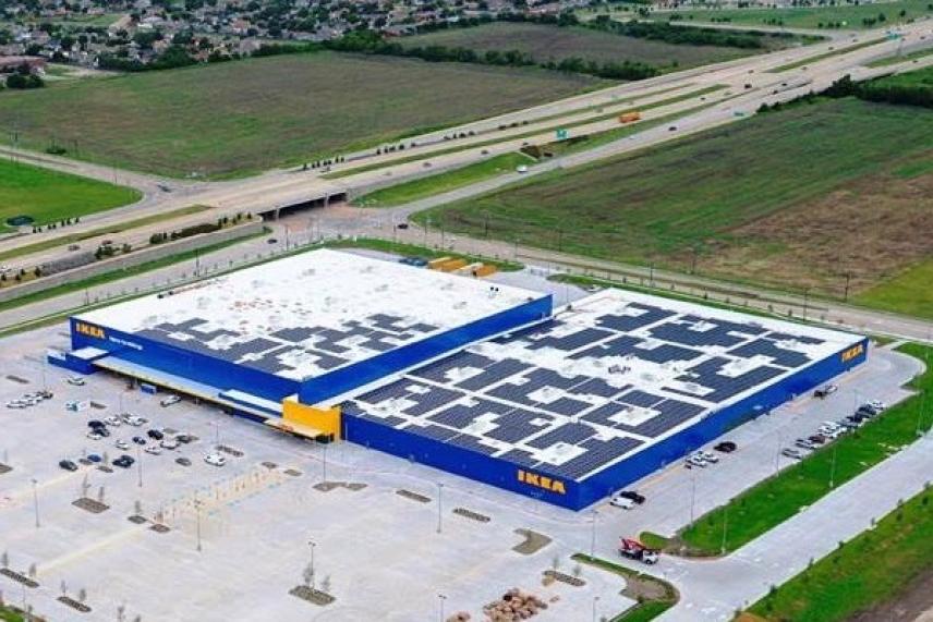 Aerial view of a large IKEA store in a spacious parking lot.