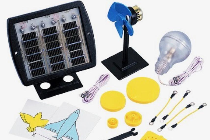 Solar energy kit with a panel, fan, light bulb, and connectors on a white background.