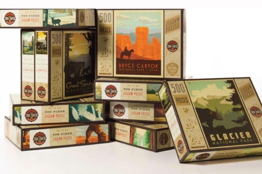 Stack of national parks-themed puzzle boxes, featuring colorful nature graphics.