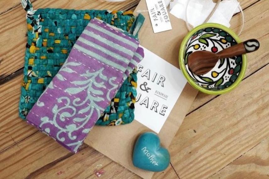 Quilted fabric, wooden spoon bowl, heart stone on wood table.