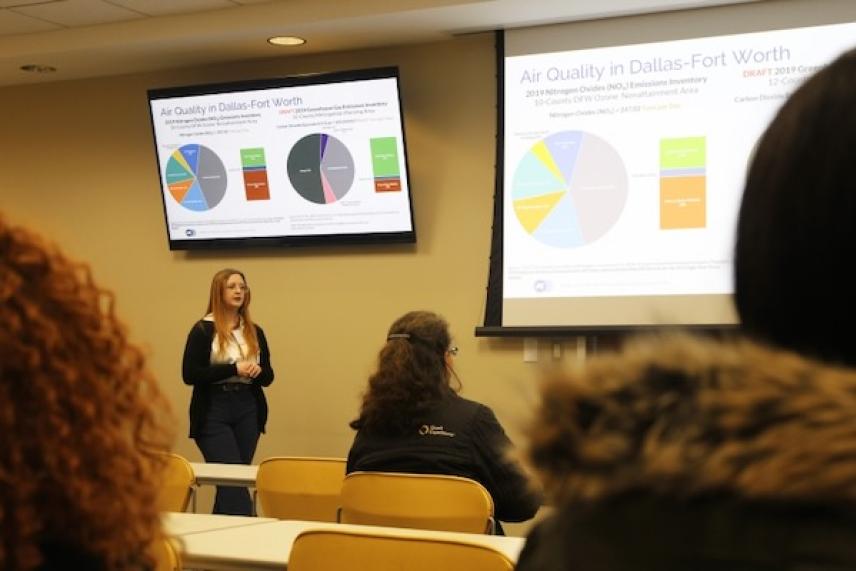 Presentation on air quality in a classroom setting with charts displayed.