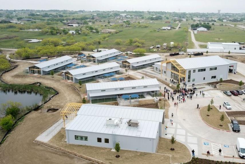 Aerial view of modern buildings in a rural landscape.