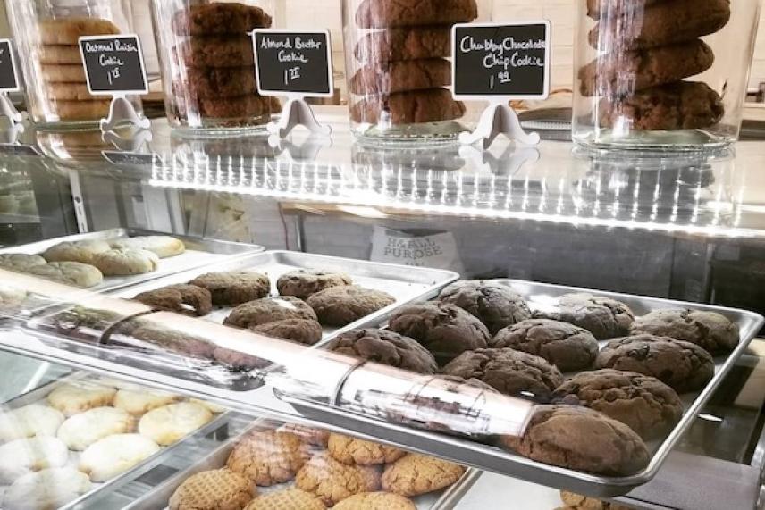 Cookies displayed in a bakery case, with chocolate and vanilla varieties.