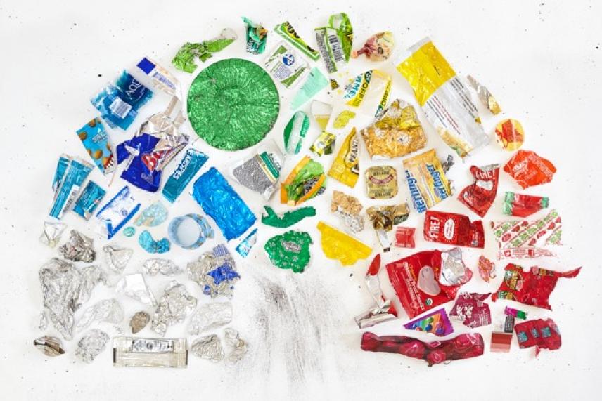 Trash arranged in a colorful pattern resembling a tree on a white background.