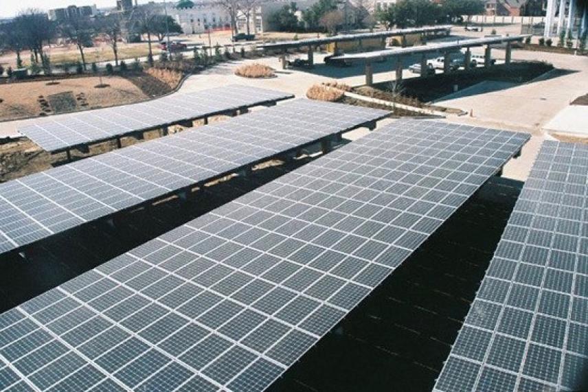 Large solar panels in an outdoor setting under a clear sky.