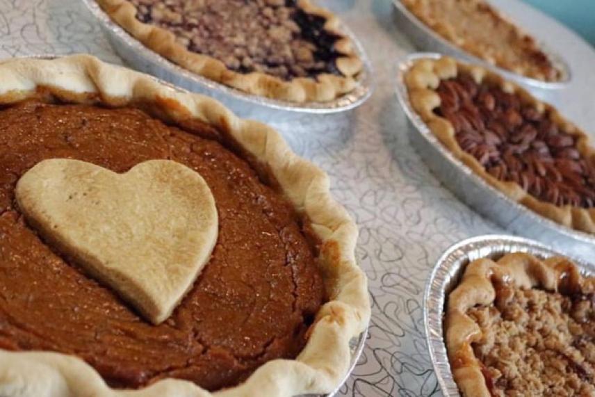 Assorted pies on a table, one topped with a heart-shaped crust.