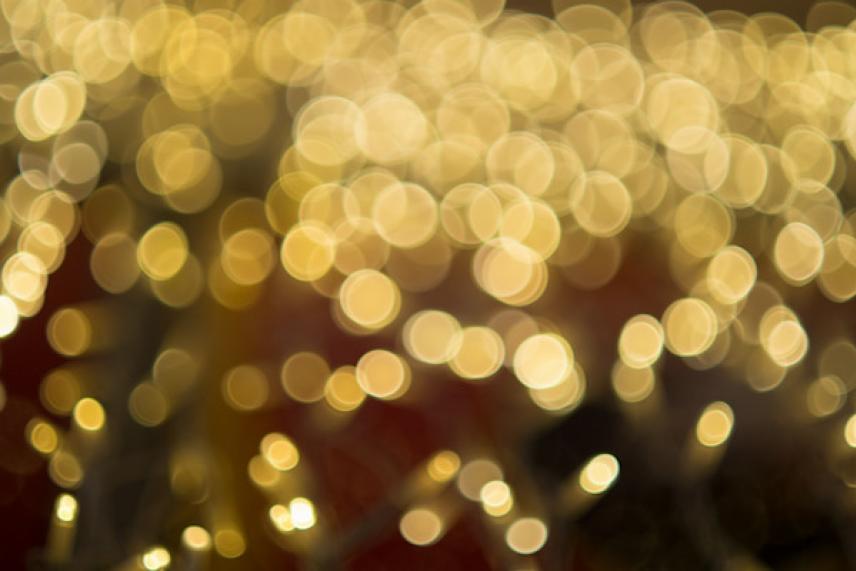 Blurry golden bokeh lights against a dark background.