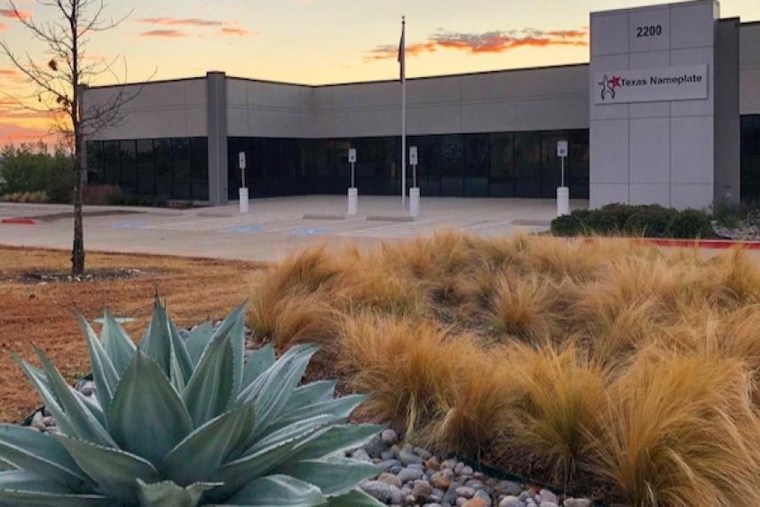Modern office building with desert landscaping at sunset.