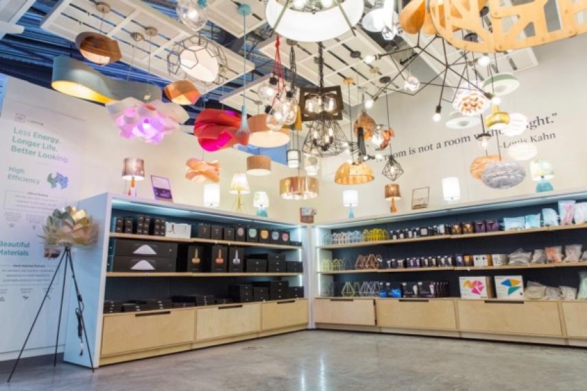 Store with assorted ceiling lamps and shelves displaying products.