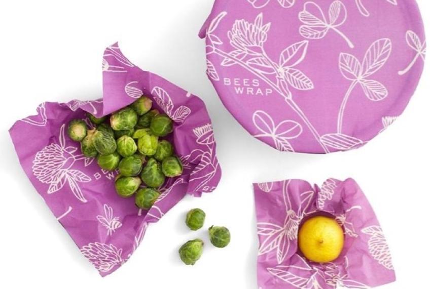 Brussels sprouts and a plum on pink floral beeswax wraps.