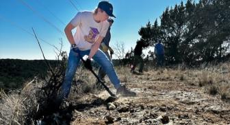Participants level a trail at the Lone Star Trail Building School