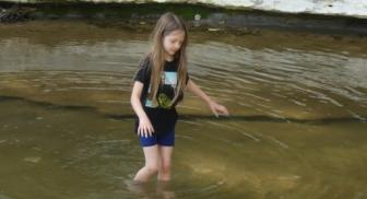 Irene wades the creek at Ladd Nature Preserve in Duncanville