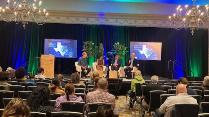 Moderator David Marquis, left, leads a panel at the Hilton Anatole in Dallas at Earth Day 2024.