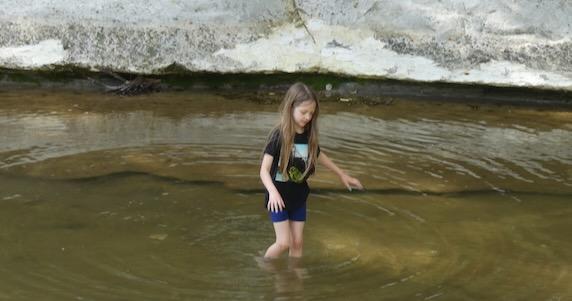 Irene wades the creek at Ladd Nature Preserve in Duncanville