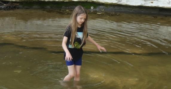 Irene wades the creek at Ladd Nature Preserve in Duncanville