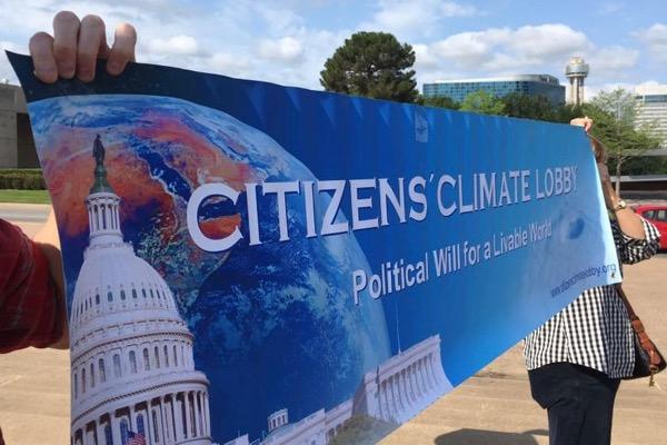 A banner reading “Citizens' Climate Lobby” in front of a blue sky.