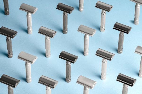 Razors arranged upright on a light blue background.