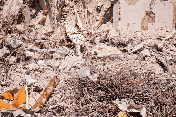 Rubble and twisted metal debris in a demolition site.