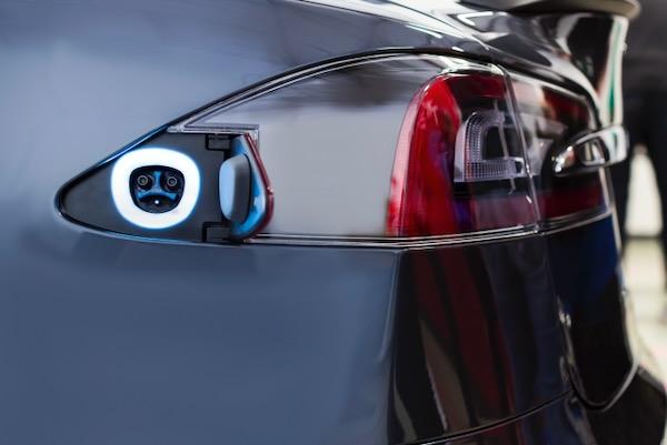 Electric car charging port on rear, with a lit ring indicator.
