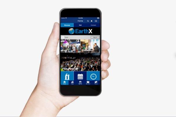 Hand holding smartphone displaying an app interface with blue headers.
