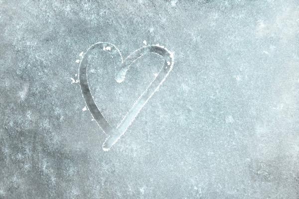 Heart drawn on frosted glass.