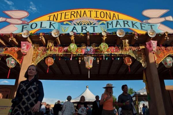 International Folk Art Market entrance with colorful decorations and a lively crowd.