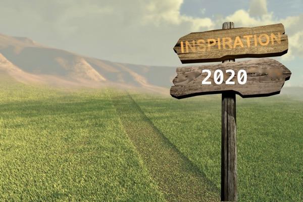 Wooden signpost in a grassy field, reading "Inspiration" and "2020."