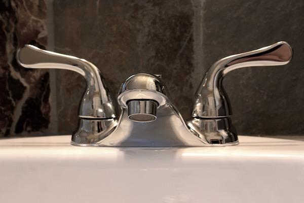 Chrome bathroom faucet with two handles.
